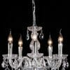 The Venice 5lt pendant features five candle-shaped bulbs, elegant glass arms, and hanging crystal pendants, creating a sparkling effect against a black background.