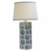 The Blue ceramic table lamp features a cylindrical blue and white patterned base and a white lampshade with a delicate blue trim.