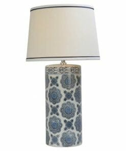 The Blue ceramic table lamp features a cylindrical blue and white patterned base and a white lampshade with a delicate blue trim.