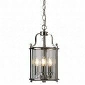 The Lantern 3lt pendant features a brushed metal finish, cylindrical glass shade, and three visible candle-style bulbs, all elegantly suspended from a chain.