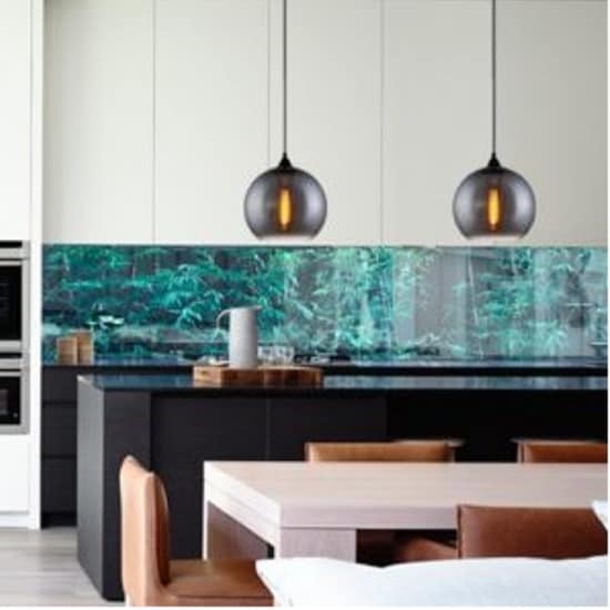 Modern kitchen with black island, brown chairs, nature-inspired backsplash with green plants, and Chuva Series pendant lights.