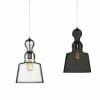 Two Campana Glass Pendant Series lights—one with a clear shade, the other with a dark translucent shade—hang on cords against a white background.