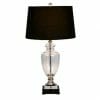 The Glass black lamp with black shades features a clear glass body, a sleek silver base, and stands on a black square pedestal, topped with an elegant black shade.