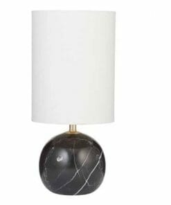 The Palazzo Table Lamp - Black showcases a round black marble base with bold white veining and a tall cylindrical white shade, offering timeless elegance.