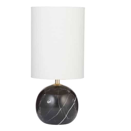 The Palazzo Table Lamp - Black showcases a round black marble base with bold white veining and a tall cylindrical white shade, offering timeless elegance.