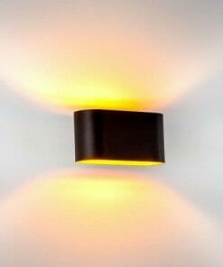 The HV8028 Wall light black is a wall-mounted fixture that casts warm yellow light both upward and downward on a white wall.