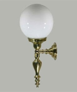 The Vattimo 1Lt wall sconce showcases an ornate brass base and a round white glass globe shade, set against a light gray background.