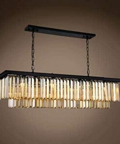 The Odeon 12 light pendant is a rectangular black metal chandelier with hanging rows of gold-tinted crystal prisms, suspended by two chains.