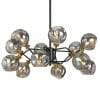 The Annabel 12 pendant is a modern chandelier with twelve spherical glass shades, exposed bulbs, black metal arms, and gold accents.