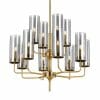 The Decrola 12 light pendant features multiple brass arms with cylindrical clear glass shades and exposed bulbs, making it a striking modern chandelier ideal for contemporary spaces.