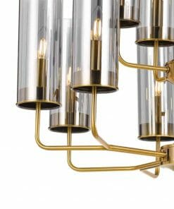 Close-up of the Decrola 12 light pendant featuring gold metal arms and cylindrical glass shades that encase exposed bulbs.