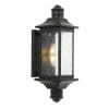 The Leeds exterior light is a black wall lantern featuring a rectangular frame, clear textured glass panels, and a visible glowing bulb inside.