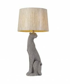 The Nala table lamp has a beige shade and a textured gray base shaped like a sitting cat, bringing playful charm to any room.