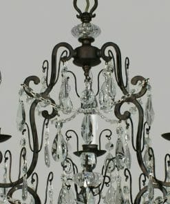 Close-up of the Salzburg 3 crystal chandelier featuring black metal arms, glass crystals, and illuminated candle-shaped bulbs against a plain gray background.