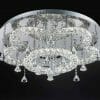 Modern ceiling chandelier with circular design, featuring Lugos C-7039 crystal CTC rings and hanging pendants against a black background.