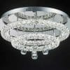 The Horos C-7548 crystal CTC is a round, modern ceiling light with multiple concentric rings and hanging crystals, beautifully contrasted against a black background.