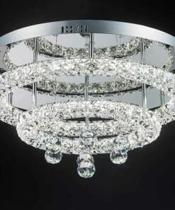 The Horos C-7548 crystal CTC is a round, modern ceiling light with multiple concentric rings and hanging crystals, beautifully contrasted against a black background.