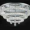 The Horos C-7548 crystal CTC ceiling chandelier features three circular, crystal-encrusted tiers and hanging crystal pendants, set against a black background.