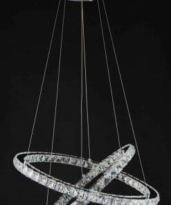 The 6 Crystal ring pendant features two interlocking crystal rings suspended by thin wires from a round chrome ceiling mount, set against a black background.