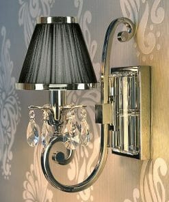 The Luxuria 1 light wall fixture boasts a black lampshade, elegant chrome accents, and crystal pendants, making it a stunning accent piece for decorative wallpaper.