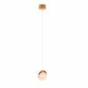 The Saturn 1 pendant showcases a copper finish and a round frosted glass bulb, hanging from the ceiling by a slim white cord for a modern, minimalist appearance.