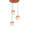 Three Saturn 1 pendant lights with copper accents are suspended at varying heights from a round copper ceiling mount.