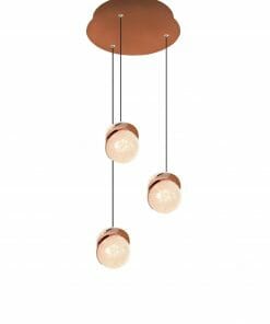 Three Saturn 1 pendant lights with copper accents are suspended at varying heights from a round copper ceiling mount.
