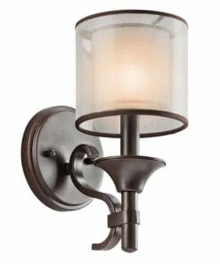 The Lacey wall light is a wall-mounted bronze sconce with a cylindrical frosted glass shade that emits soft, warm light.