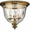 The Cambridge 3 small range brass and glass flush mount features three candle-style bulbs, offering classic elegance and ideal illumination for compact spaces.