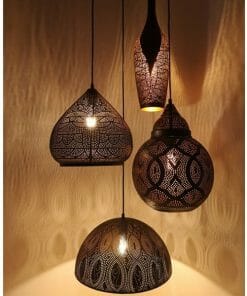 Four Marrakesh 1 pendant lamps hang from the ceiling, casting warm light and decorative shadows on the wall.