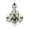 The Louis 15th 24 bronze is an ornate black metal chandelier with twelve candle-style lights, crystal pendants, and a chain suspension, finished in elegant 24 bronze.