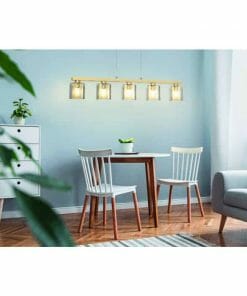 Small dining area featuring a wooden table, two white chairs, Castralvo 5 as a potted plant centerpiece, a white cabinet, and modern pendant lighting against a light blue wall.