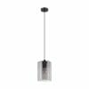 The Castralvo 1 Amber pendant light showcases a cylindrical clear glass shade, black metal fixture, and exposed bulb suspended from a sleek black cord.