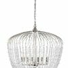 A silver chandelier with curved metal arms and hanging crystal beads, suspended by a chain, perfectly complements the Evelyn black 4 collection.