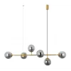 The Eevee 6 Brass amber chandelier features a brass horizontal rod with six amber-tinted spherical glass lights, suspended from the ceiling by two thin wires.