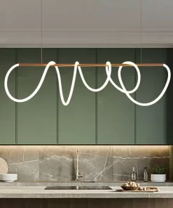 Modern kitchen with green cabinets, marble backsplash, and a large, abstract Swife Linear pendant hanging above the countertop with a bowl and bottles.