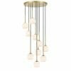 The Bobo 4 brass bar chandelier features a gold circular base with nine white frosted glass pendants hanging at different lengths for a modern look.