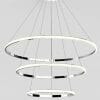 The Tuscan 3 ring black ceiling light features three circular LED rings suspended by cables from a round base, presented against a plain background.