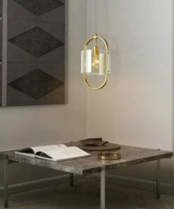 A Dynamical smoke pendant hangs above a square stone table holding an open book and trays, beside a wall decorated with geometric dark panels.