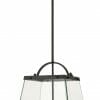 The Colair solid brass Black 4 is a pendant light with four exposed bulbs arranged in a square within a trapezoidal metal and glass frame.