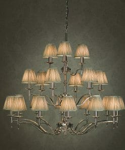 The Standford 21 Chrome Shimmer grey chandelier features multiple tiers and lampshades, elegant metal arms, and a central support, all brilliantly illuminated against a plain dark background.