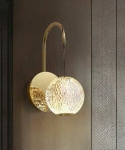 The Langton 1 black wall sconce showcases a round, textured glass shade that glows elegantly against a textured brown wall.