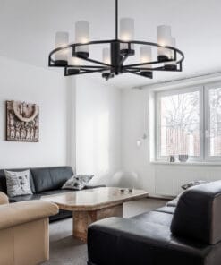 A black and white living room with a Devon 8 light Antique brass, inspired by a lighting store aesthetic.