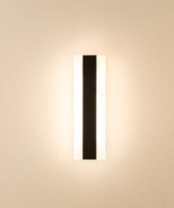 The Berlin 30 Range wall sconce is rectangular with a central black vertical stripe, casting gentle light across a beige wall for a modern look.