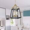 Modern gold-accented pendant light in white kitchen.