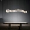 Modern curved light above minimalist concrete table