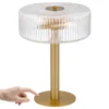Gold table lamp with ribbed glass shade and finger pointing