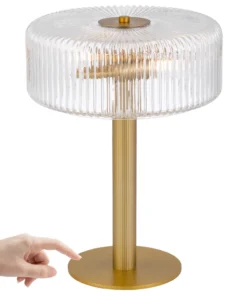 Gold table lamp with ribbed glass shade and finger pointing