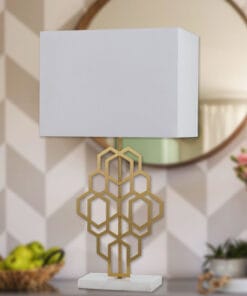 Geometric gold lamp on white tabletop